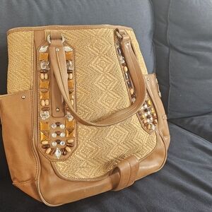 Dazzling Jewled Haan weaved leather bag.
